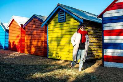 Full length of woman standing against building