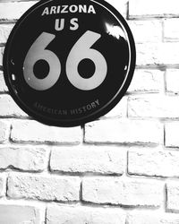 Low angle view of text on brick wall