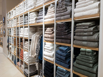 Shelves of bed clothe and bath towels in home decore shop