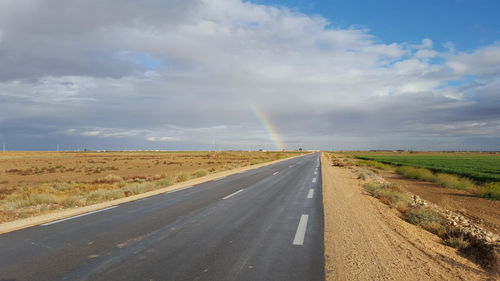 Empty road along countryside landscape