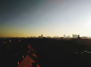 Cityscape against clear sky during sunset