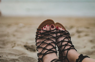 Low section of woman standing on beach