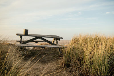 Lifeguard hut on field against sky