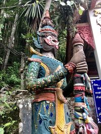 Statue of buddha against trees