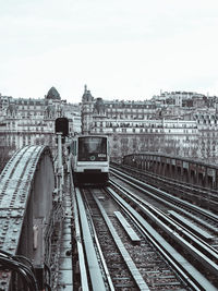 Train at railroad station against sky