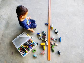 High angle view of boy playing with toy at home