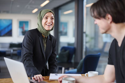 Smiling woman talking in office