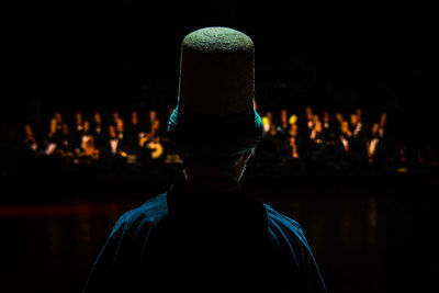 Close-up of man wearing sunglasses against sky at night