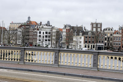 View of city buildings against cloudy sky