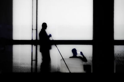 Silhouette men standing in corridor