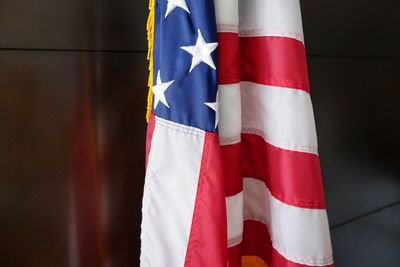 Close-up of american flag against blurred background