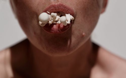 Close-up of woman eating mushroom