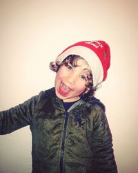 Portrait of smiling boy against wall