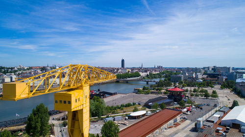 High angle view of crane in city against sky