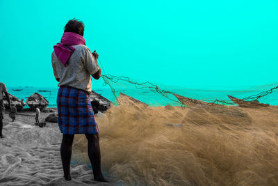 Rear view of woman with umbrella walking on land