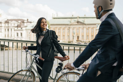 Full length of man riding bicycle in city