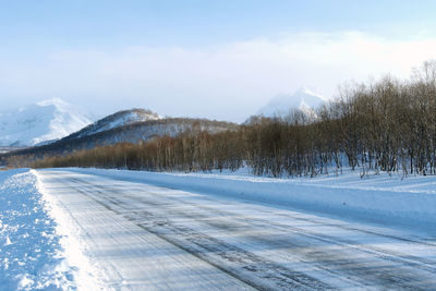 Scenic view of snow covered mountains against sky