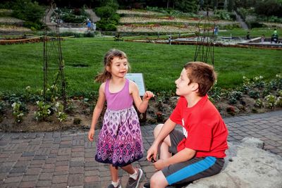 Cute siblings talking in park