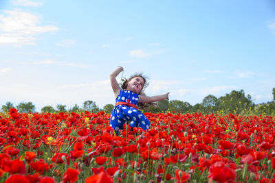 View of boy with daisy flowers in field