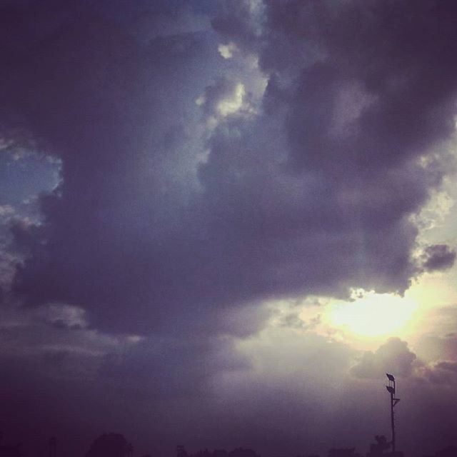 sky, cloud - sky, low angle view, cloudy, beauty in nature, scenics, silhouette, tranquility, cloudscape, nature, weather, tranquil scene, cloud, overcast, dramatic sky, sunbeam, storm cloud, idyllic, atmospheric mood, outdoors