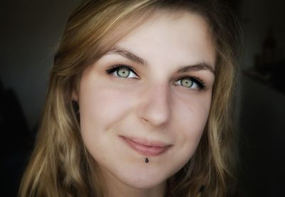 Close-up portrait of smiling young woman