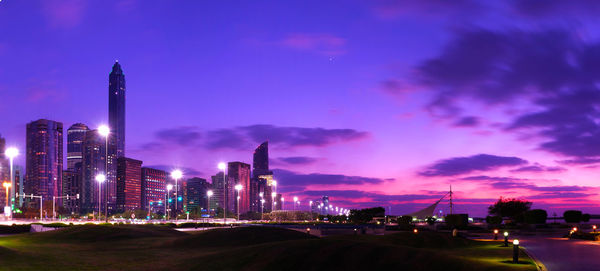 Panoramic view of illuminated buildings against sky at night