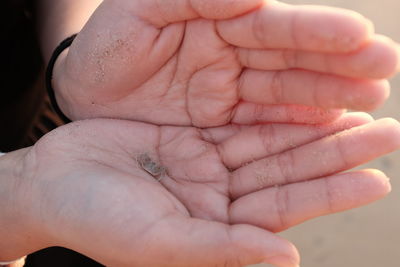 Close-up of hand holding small baby