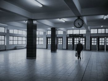 Rear view full length of man walking in building