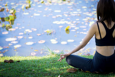 Midsection of woman sitting on grass