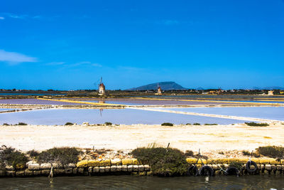 Scenic view of beach against blue sky