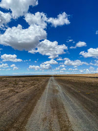 Empty road along countryside landscape