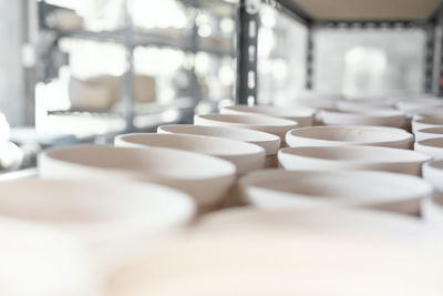 Close-up of white cups on table