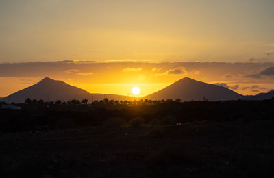 Scenic view of silhouette landscape against sky during sunset