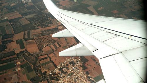 Close-up of airplane wing in city