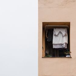 Clothes hanging on wall of building