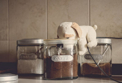 Close-up of stuffed toy on jar at table