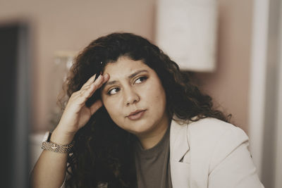 Worried businesswoman looking away at office