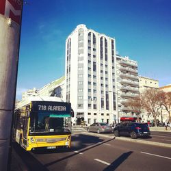 View of city street and buildings against clear sky