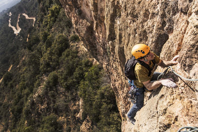High angle view of man rock climbing