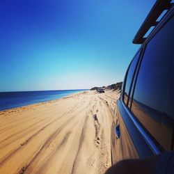 Panoramic view of beach against clear blue sky