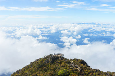 Low angle view of clouds over mountain against sky