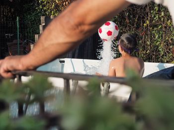 Rear view of shirtless woman