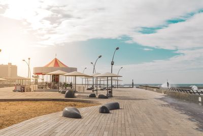 Promenade by sea against sky