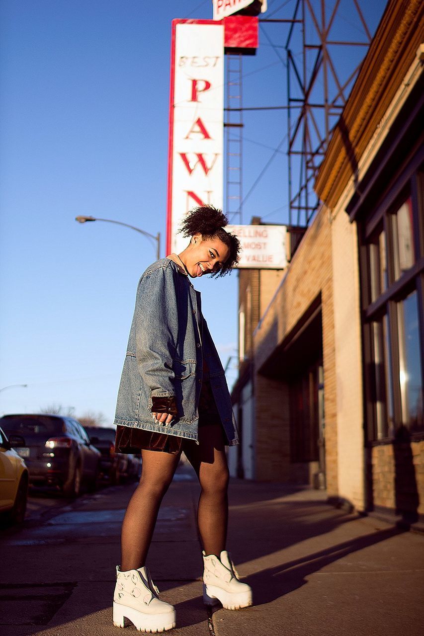 WOMAN STANDING AGAINST CLEAR SKY