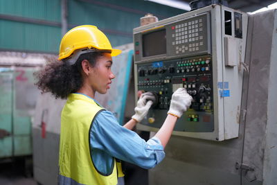 Rear view of man working in factory