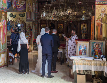 People in temple outside building