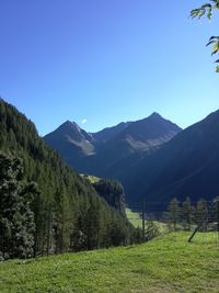 Scenic view of mountains against clear blue sky