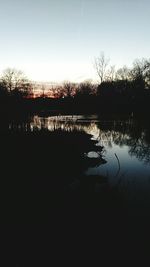 Scenic view of lake against sky at sunset