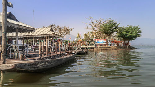 Boats moored in river against sky