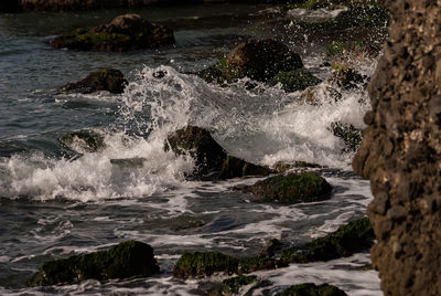Scenic view of sea waves splashing on rock formation